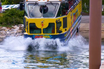 a passenger bus that is driving down the river